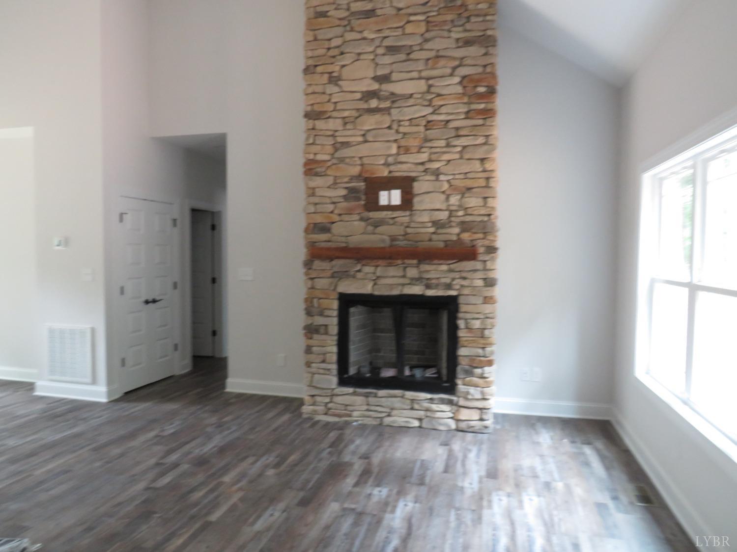 40 Hawkins Road Evington, VA 24550 - Photo 8 of 14 a view of an empty room with wooden floor and a window