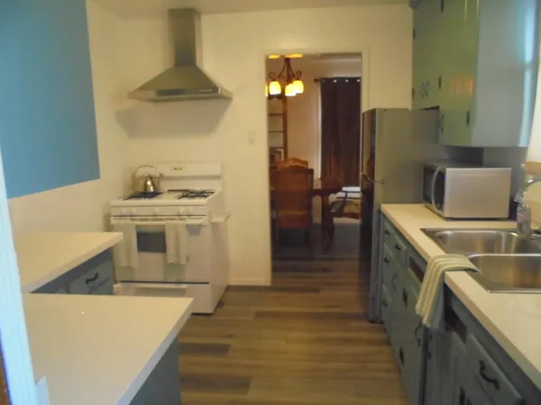 a kitchen with a stove and a refrigerator