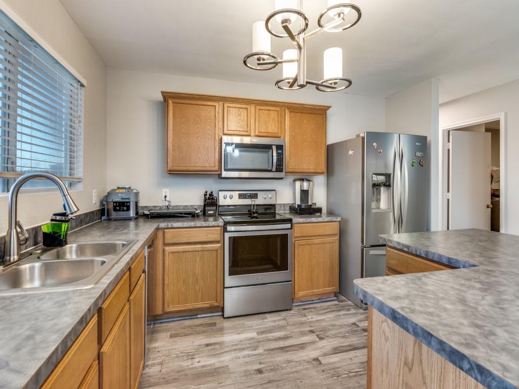 147 Washington Way Venus, TX 76084 - Photo 13 of 24 a kitchen with stainless steel appliances granite countertop a sink a stove and refrigerator
