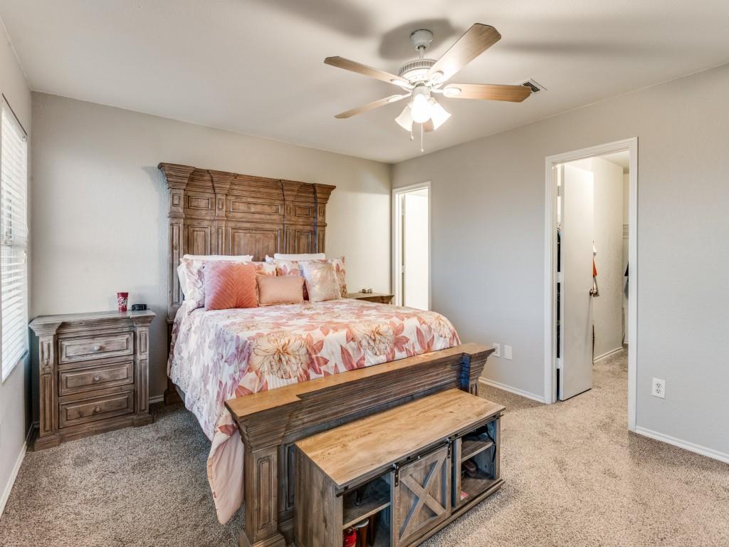 147 Washington Way Venus, TX 76084 - Photo 16 of 24 a bedroom with a bed and a chandelier