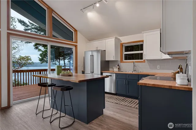 a kitchen with stainless steel appliances granite countertop a sink and wooden cabinets