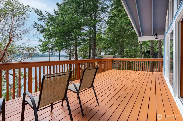 a view of balcony with wooden floor and outdoor seating