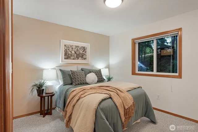 a bedroom with a bed and a window