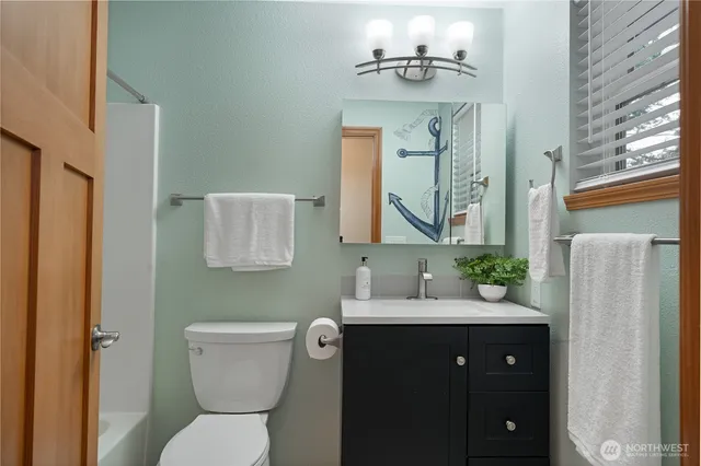 a bathroom with a toilet sink and mirror