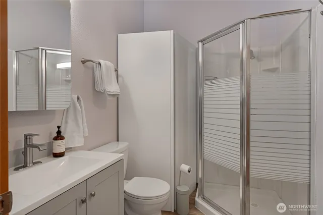 a bathroom with a granite countertop sink toilet and shower