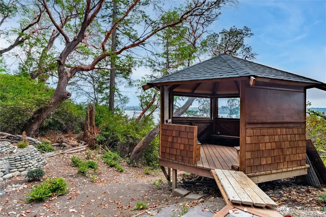 a view of backyard with deck and outdoor seating