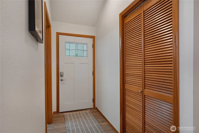 a view of hallway with wooden floor