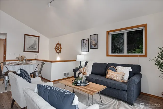 a living room with furniture a rug and a window