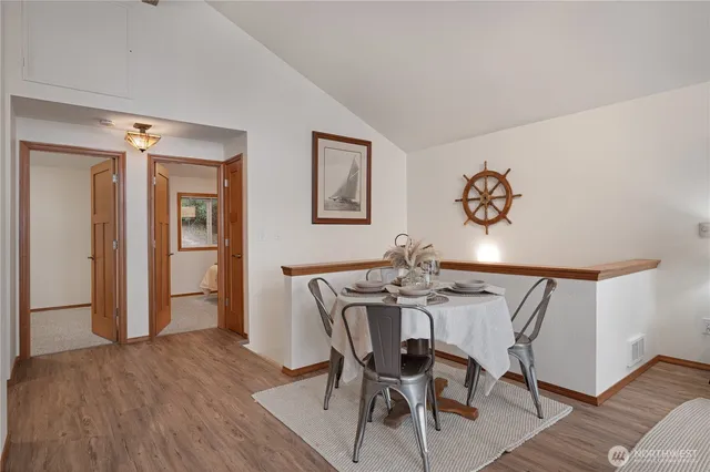 a view of a dining room with furniture and wooden floor