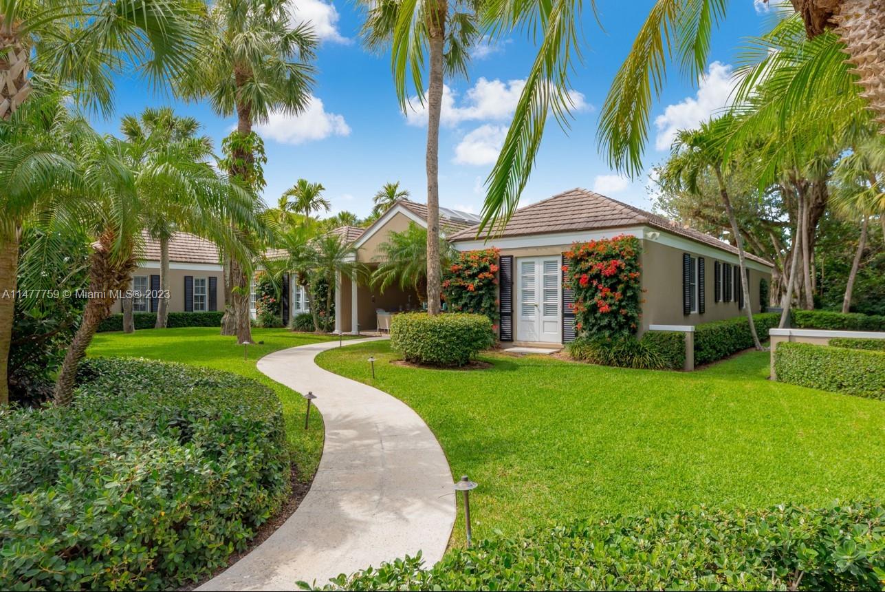 111 Gomez Road Hobe Sound, FL 33455 - Photo 3 of 16 a front view of a house with a yard