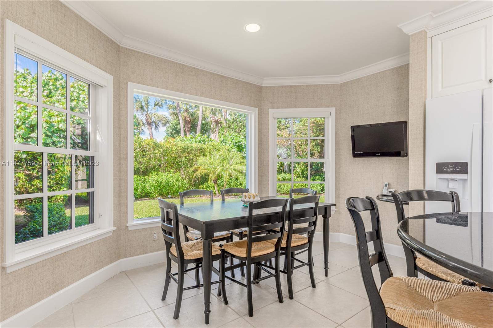 111 Gomez Road Hobe Sound, FL 33455 - Photo 8 of 16 a view of a dining room with furniture and a flat screen tv