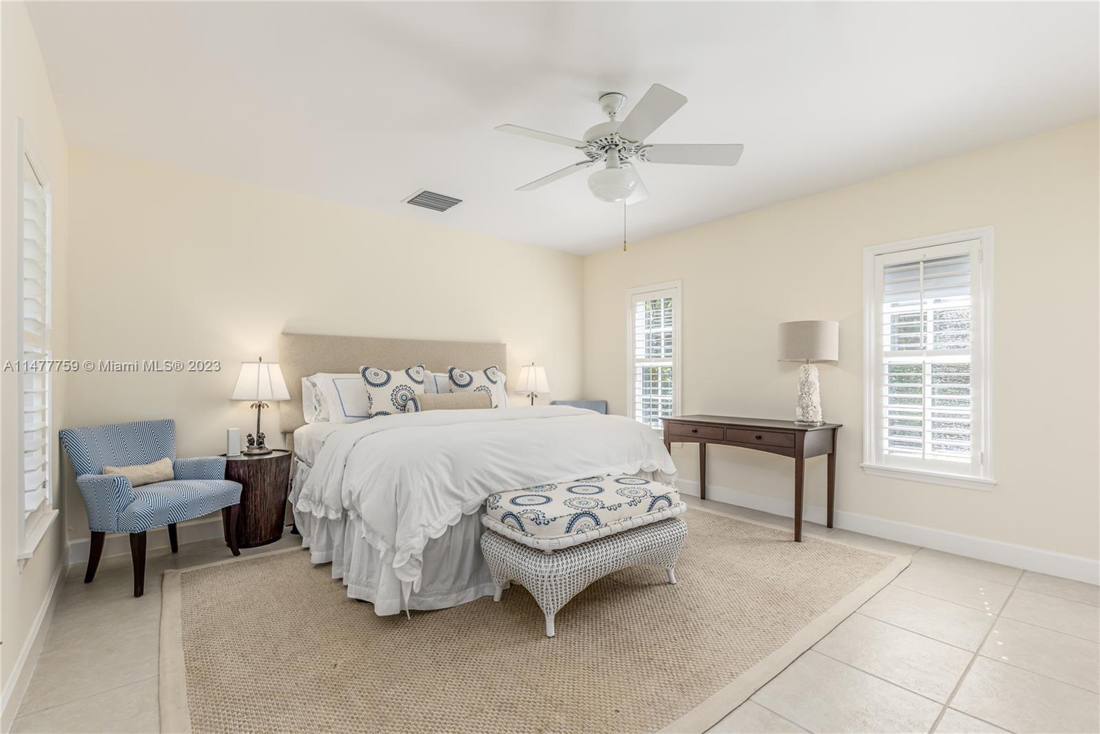 111 Gomez Road Hobe Sound, FL 33455 - Photo 9 of 16 a spacious bedroom with a bed and a chandelier