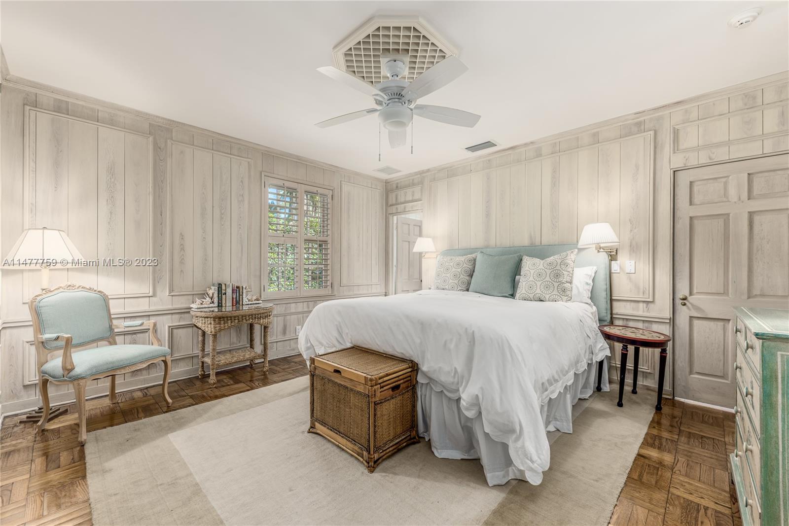 111 Gomez Road Hobe Sound, FL 33455 - Photo 10 of 16 a bedroom with a bed a table chair and a chandelier