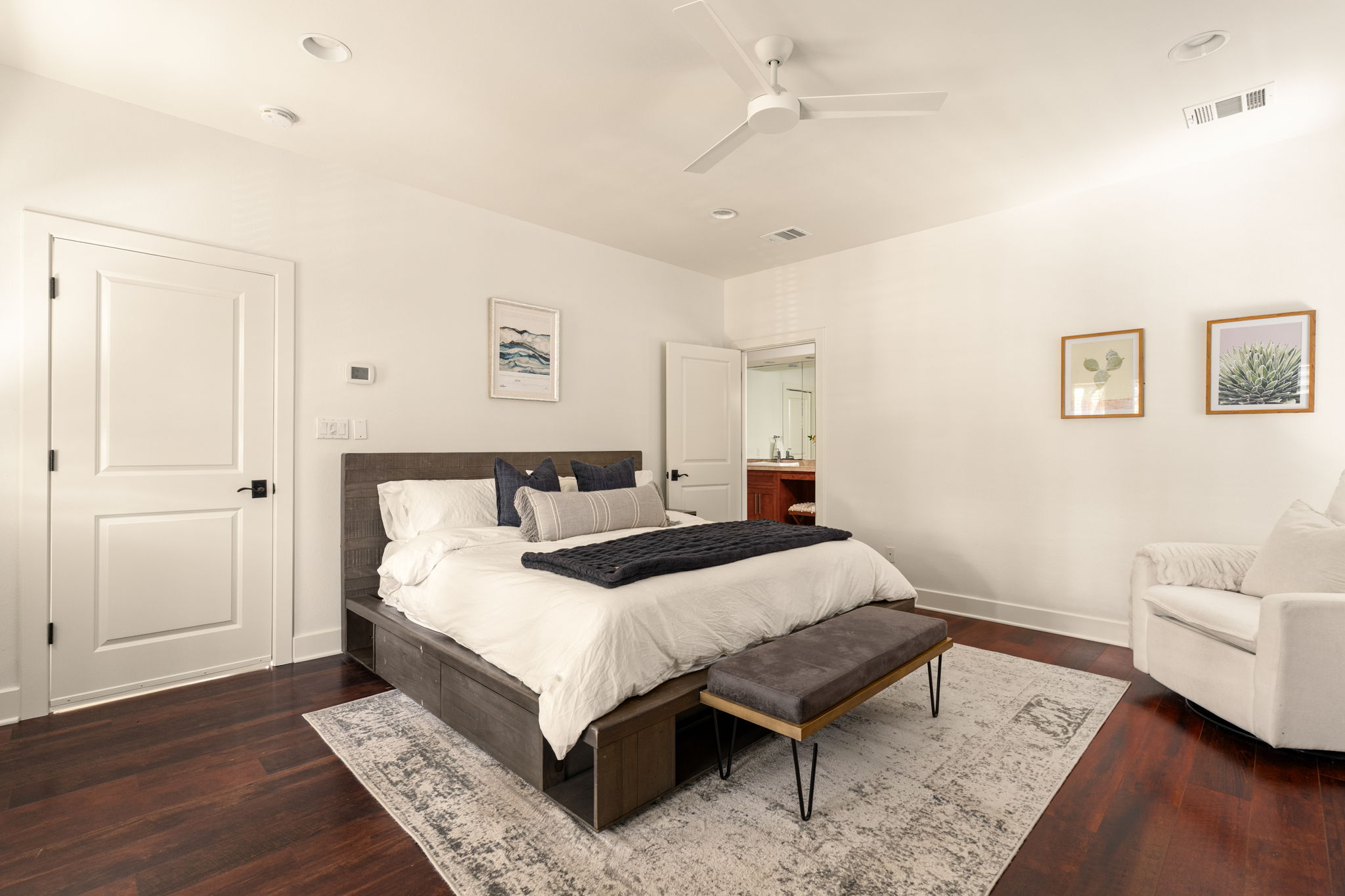 2324 Kinney Road Austin, TX 78704 - Photo 16 of 35 Rich hardwood flooring anchors this serene sleeping space featuring recessed lighting and clean architectural lines.