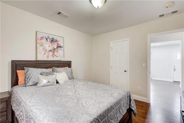 a bedroom with a bed and a mirror