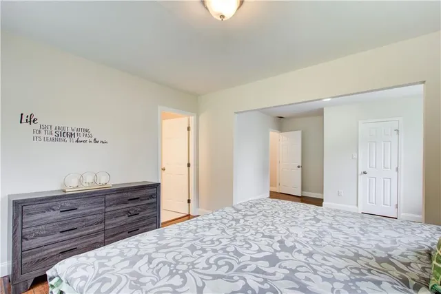 a view of a small house with a small yard and large tree