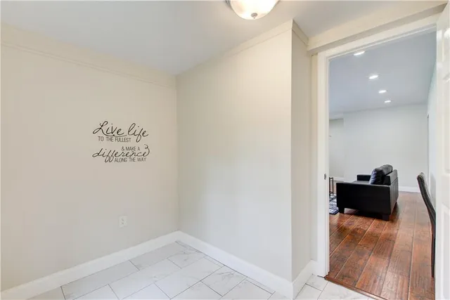 a living room with furniture fireplace and a large window
