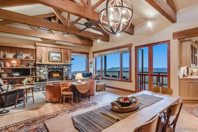 a living room with furniture a rug and a floor to ceiling window