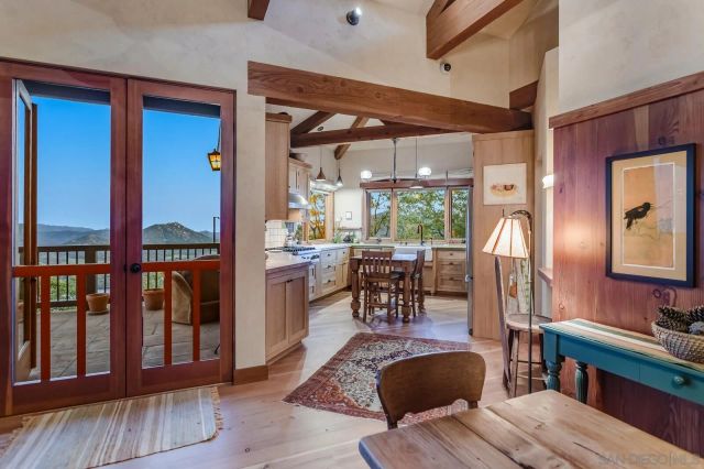 a kitchen with stainless steel appliances granite countertop a refrigerator a sink dishwasher a stove and white countertops with wooden floor