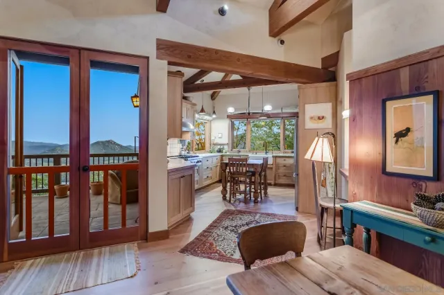 a kitchen with stainless steel appliances granite countertop a refrigerator a sink dishwasher a stove and white countertops with wooden floor