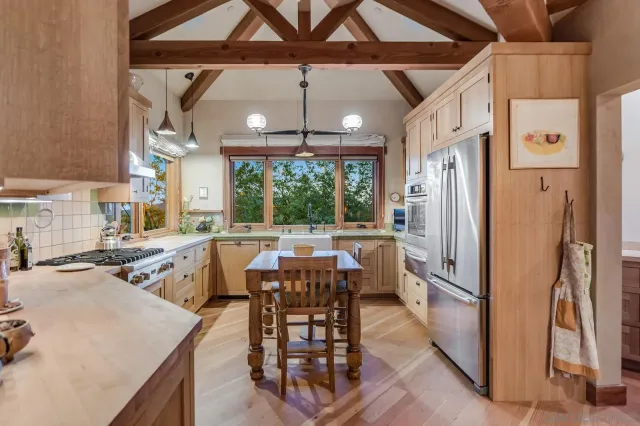a living room with furniture a fireplace and a chandelier