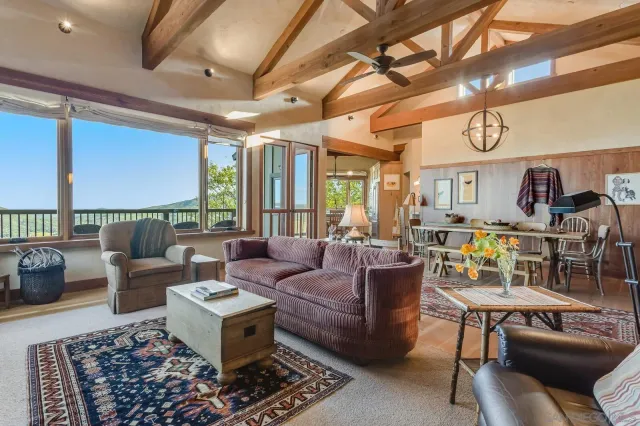 a living room with furniture and a chandelier