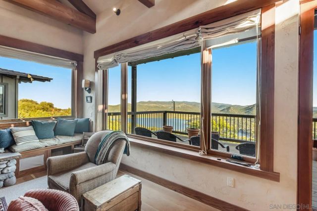 a kitchen with stainless steel appliances granite countertop a dining table chairs sink and cabinets