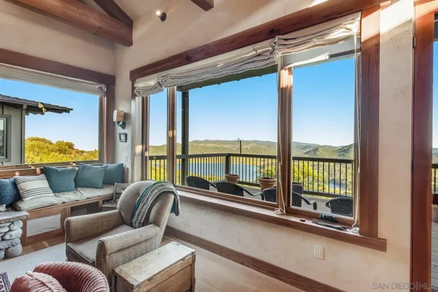 a kitchen with stainless steel appliances granite countertop a dining table chairs sink and cabinets