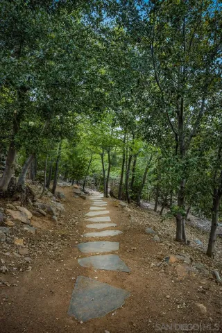 an empty room with a bathroom and mirror