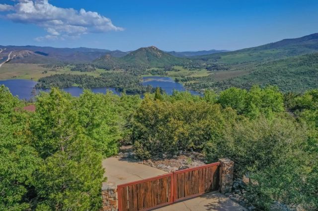 a living room with furniture a wooden floor and a chandelier