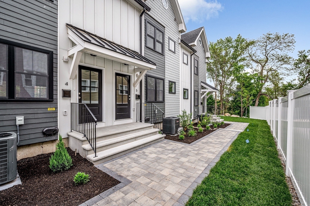 1514 Gorham Street, Unit 4 Lowell, MA 01852 - Photo 1 of 42 a view of a house with backyard sitting area and garden