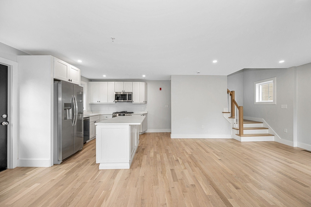 1514 Gorham Street, Unit 4 Lowell, MA 01852 - Photo 13 of 42 a view of a kitchen with a sink refrigerator and a stove top oven