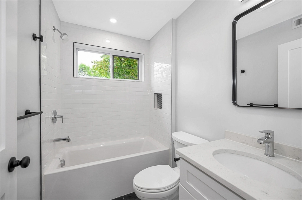 1514 Gorham Street, Unit 4 Lowell, MA 01852 - Photo 14 of 42 a bathroom with a granite countertop toilet sink and bathtub