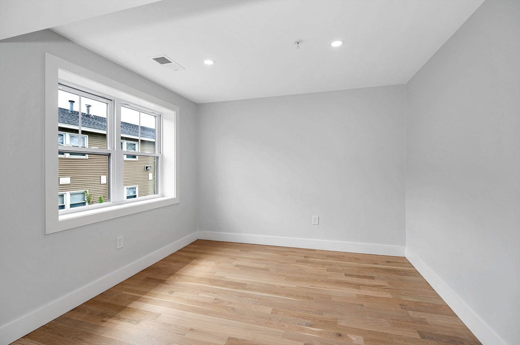 1514 Gorham Street, Unit 4 Lowell, MA 01852 - Photo 19 of 42 wooden floor in an empty room with a window