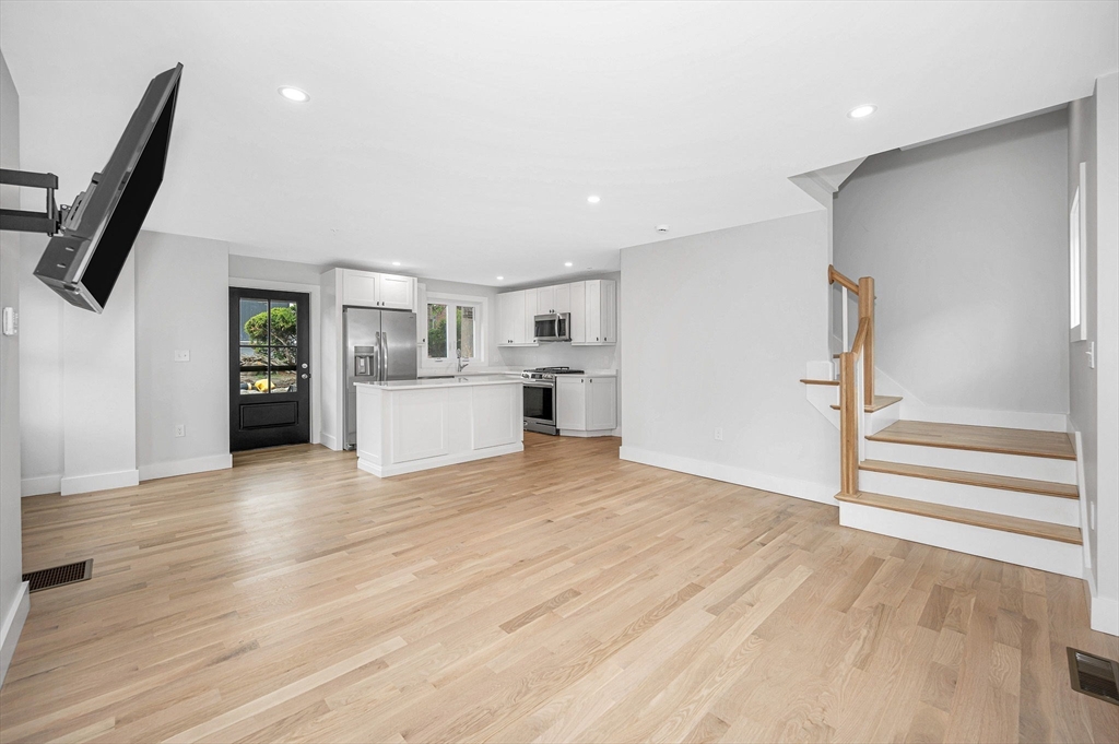 1514 Gorham Street, Unit 4 Lowell, MA 01852 - Photo 2 of 42 a view of a kitchen with wooden floor and a refrigerator