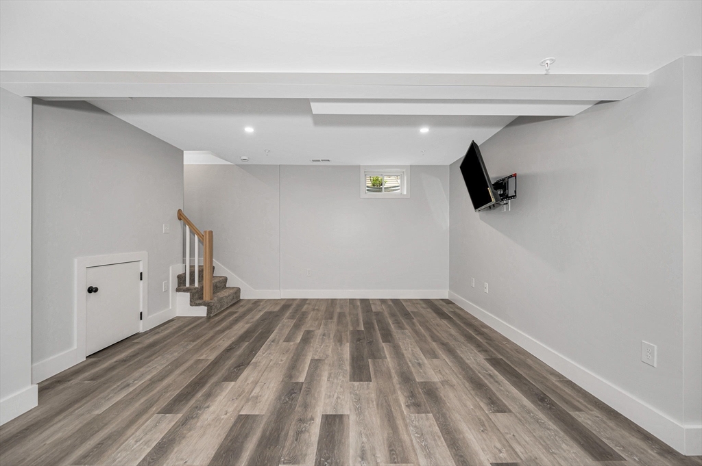 1514 Gorham Street, Unit 4 Lowell, MA 01852 - Photo 27 of 42 a view of empty room with wooden floor and windows