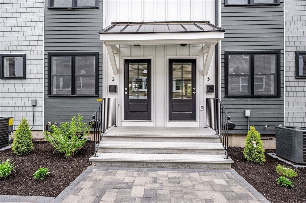 1514 Gorham Street, Unit 4 Lowell, MA 01852 - Photo 37 of 42 a front view of a house with plants and outdoor seating