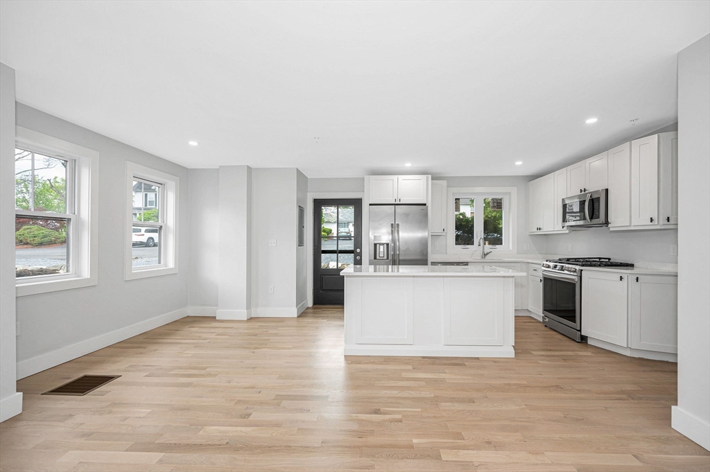 1514 Gorham Street, Unit 4 Lowell, MA 01852 - Photo 6 of 42 a kitchen with granite countertop a stove top oven sink and cabinets