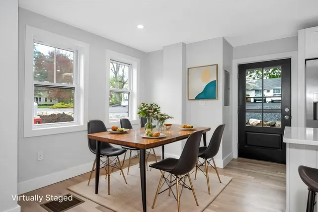 a dining room with furniture and window