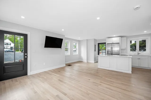 a view of a kitchen with microwave and refrigerator