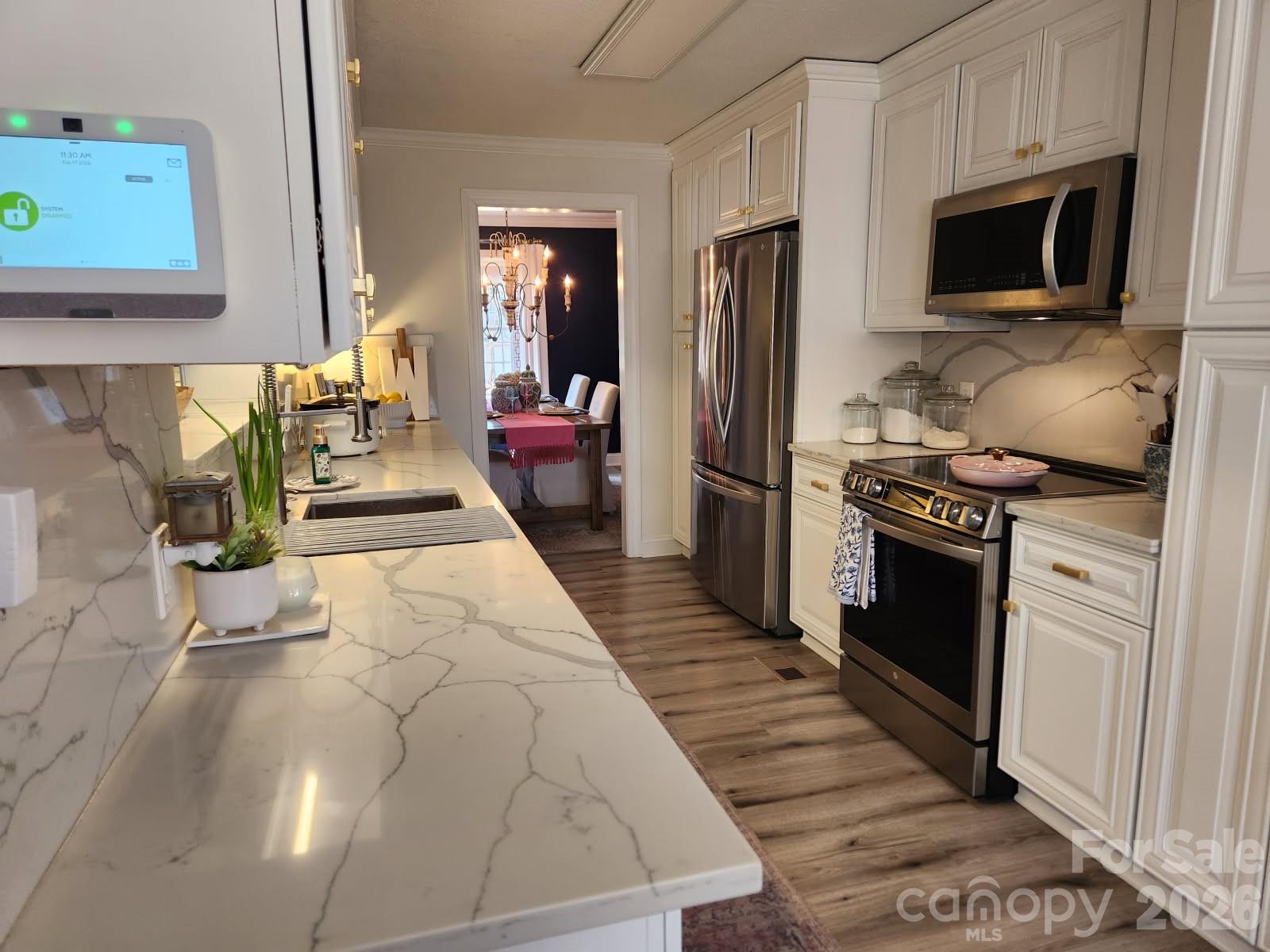 1414 Clark Place Lancaster, SC 29720 - Photo 17 of 41 a kitchen with stainless steel appliances a stove microwave and cabinets