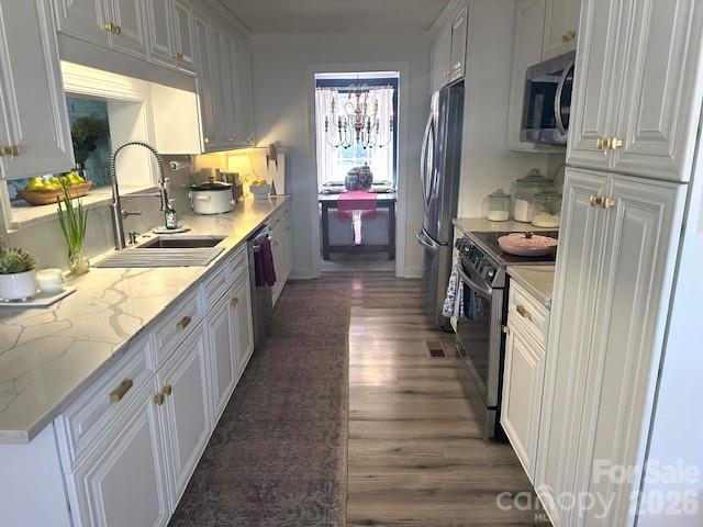 1414 Clark Place Lancaster, SC 29720 - Photo 19 of 41 a kitchen with sink cabinets and wooden floor