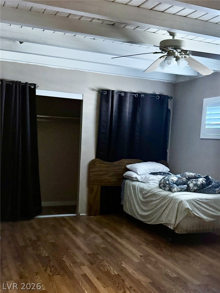167 East Robindale Road Las Vegas, NV 89123 - Photo 14 of 15 Exposed ceiling beams and rich wood flooring define this comfortable bedroom space.
