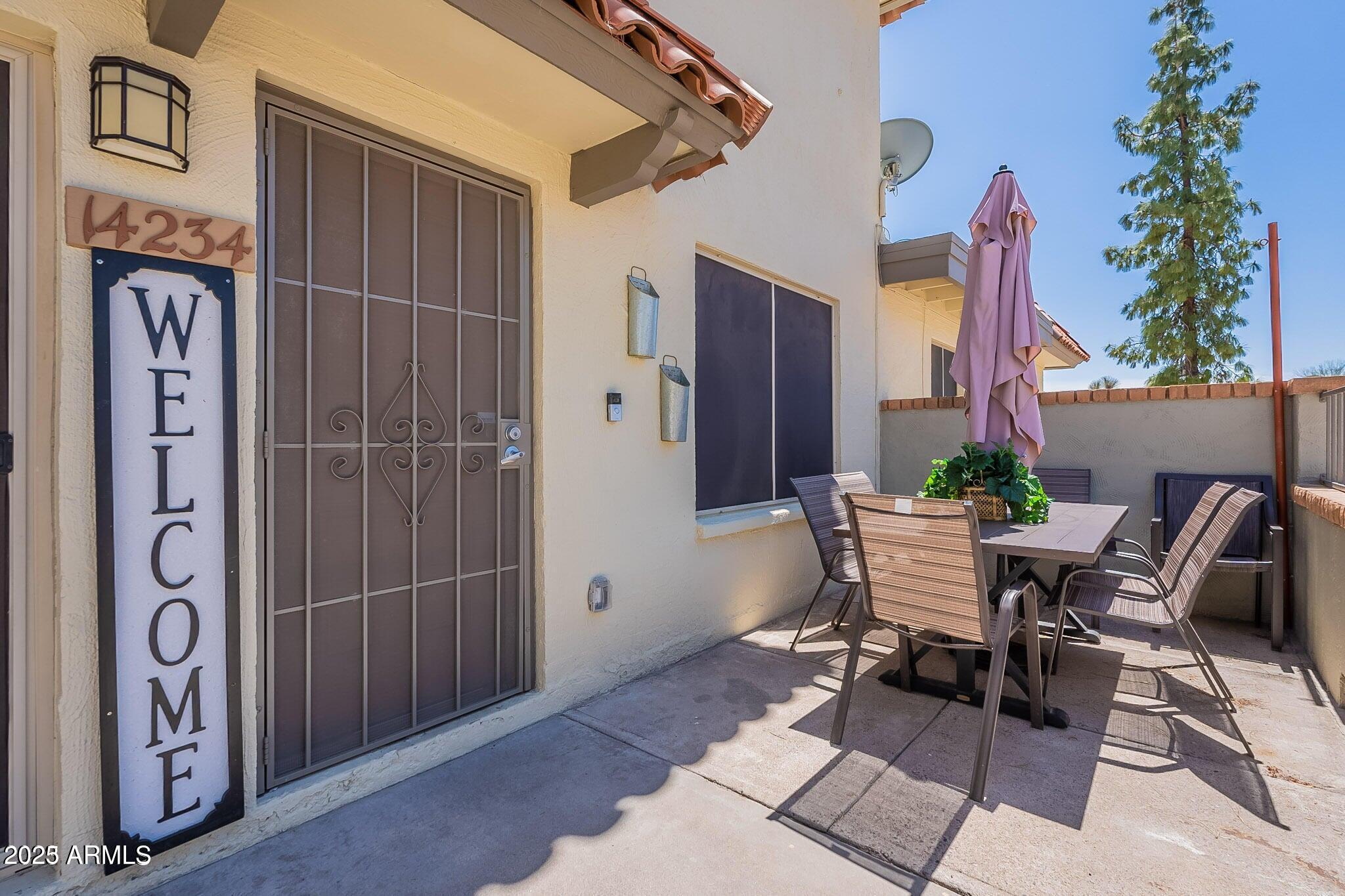 14234 North Oakwood Lane, Unit C Fountain Hills, AZ 85268 - Photo 2 of 22 a patio with a table and chairs