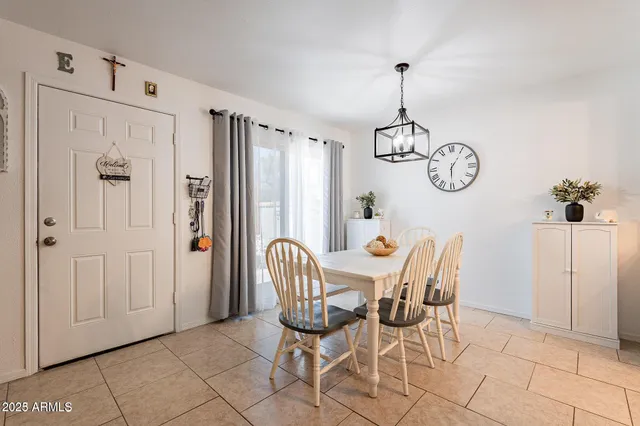 a kitchen with stainless steel appliances granite countertop a dining table and chairs