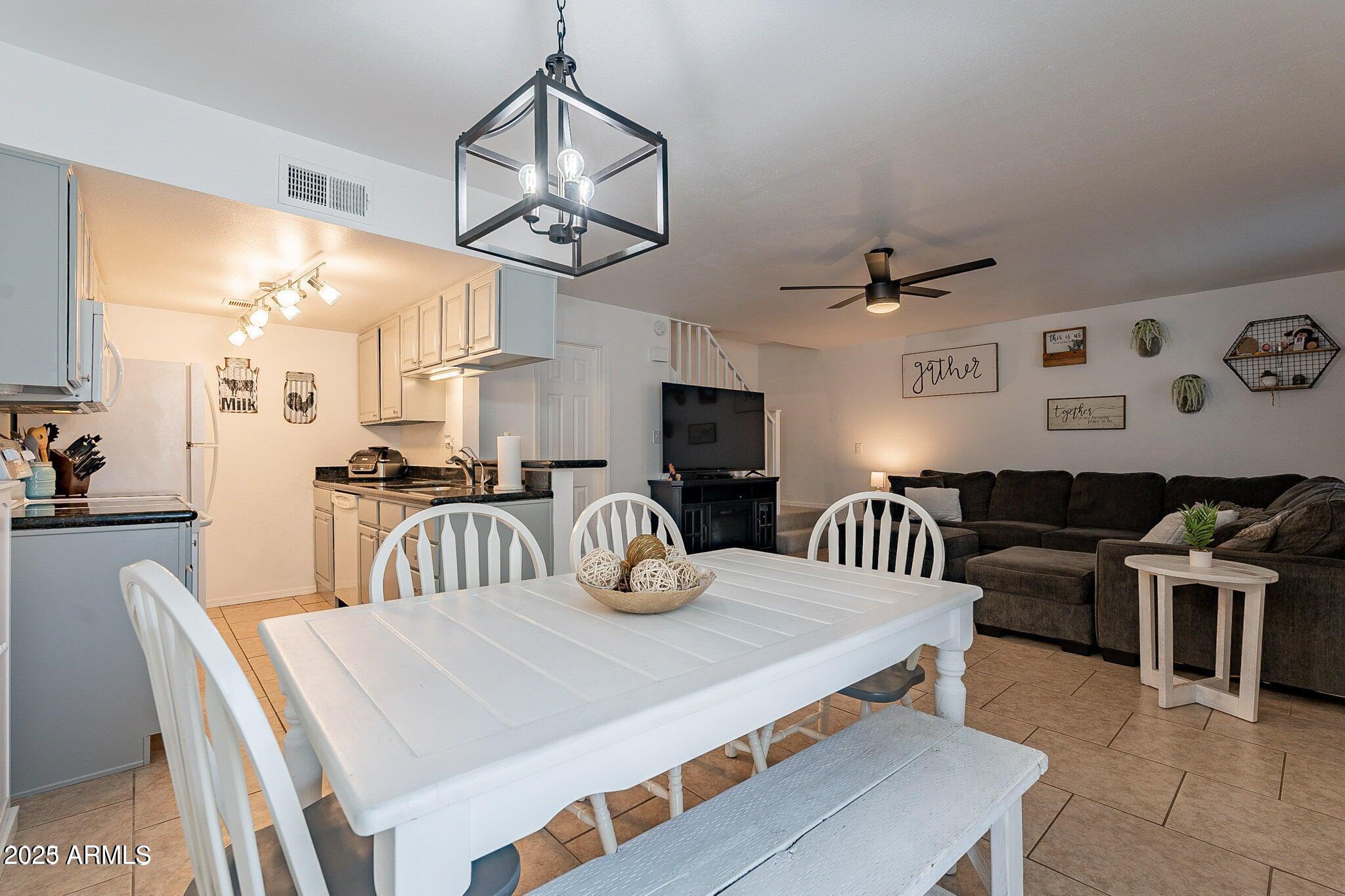 14234 North Oakwood Lane, Unit C Fountain Hills, AZ 85268 - Photo 5 of 22 a kitchen with stainless steel appliances granite countertop a dining table and chairs
