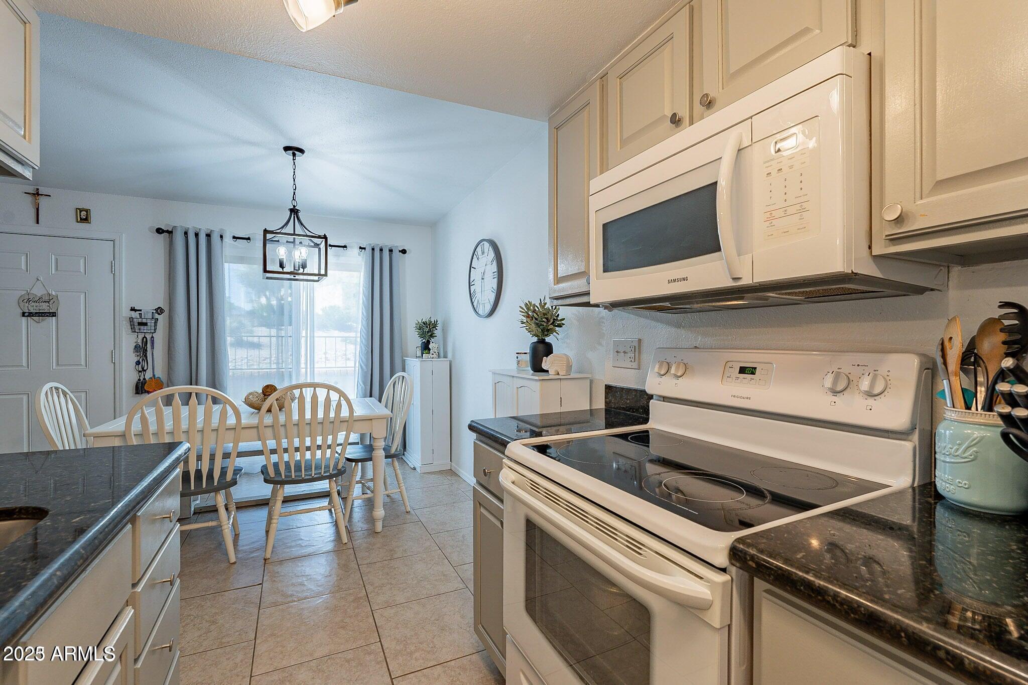 14234 North Oakwood Lane, Unit C Fountain Hills, AZ 85268 - Photo 9 of 22 a kitchen with a stove and a microwave