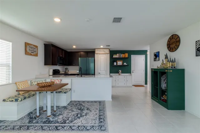 a open kitchen with stainless steel appliances granite countertop a stove refrigerator and a sink