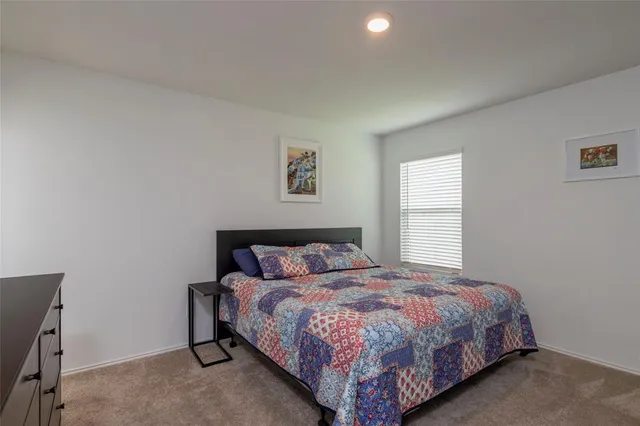 a bedroom with a bed and a dresser