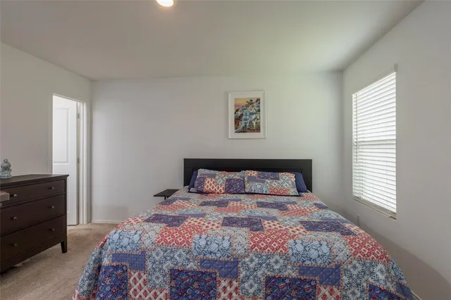 a bedroom with a bed and flat screen tv